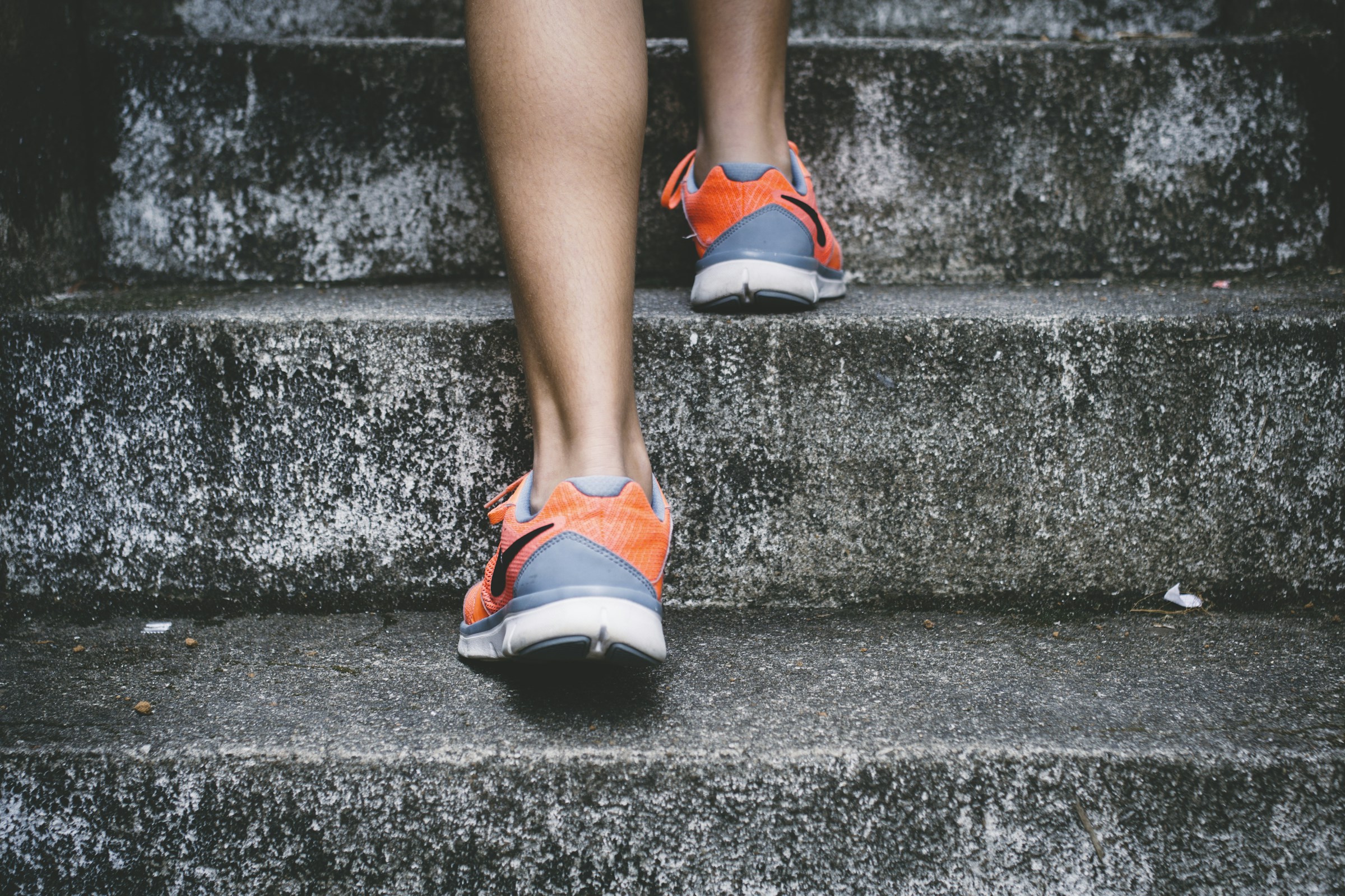 Running shoes on a textured outdoor surface before a workout